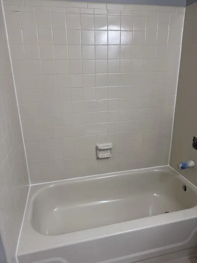 Bathtub and white tile surround refinished to a clean bright white
