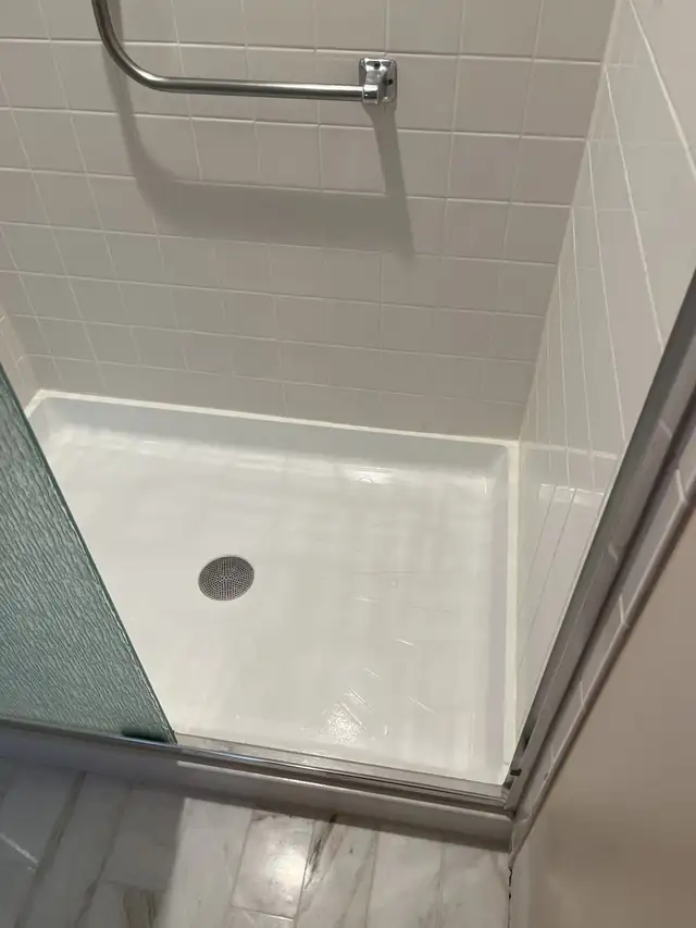 Small stand-up shower with the pan refinished bright white